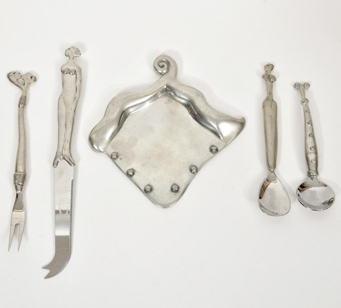5-Piece Silverware Set by Carol Boyes: Includes: 9" cheese knife and 7.5" fork, 5.5" soup spoon, 6.5" spoon and a 5" x 5" spoon rest. Some handles depict nude figures. Total weight - 23.26oz. Condition report: Good, no issues, please exami