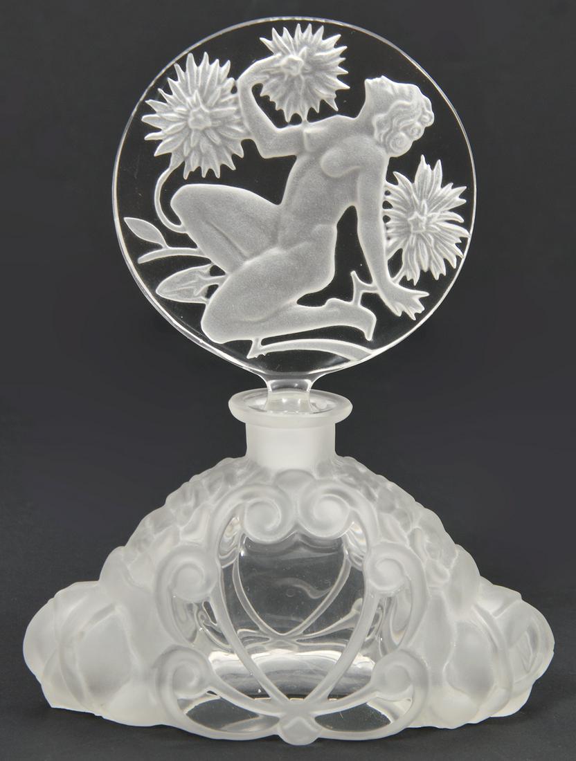 Czech Perfume Bottle Art Deco Intaglio Stopper: Czech Deco perfume bottle with round intaglio of kneeling nude with chrysanthemums, in style of Pesnicak, 5"L x 7"H Condition report: Good, no issues, please examine all photos closely. Contact C. Bid