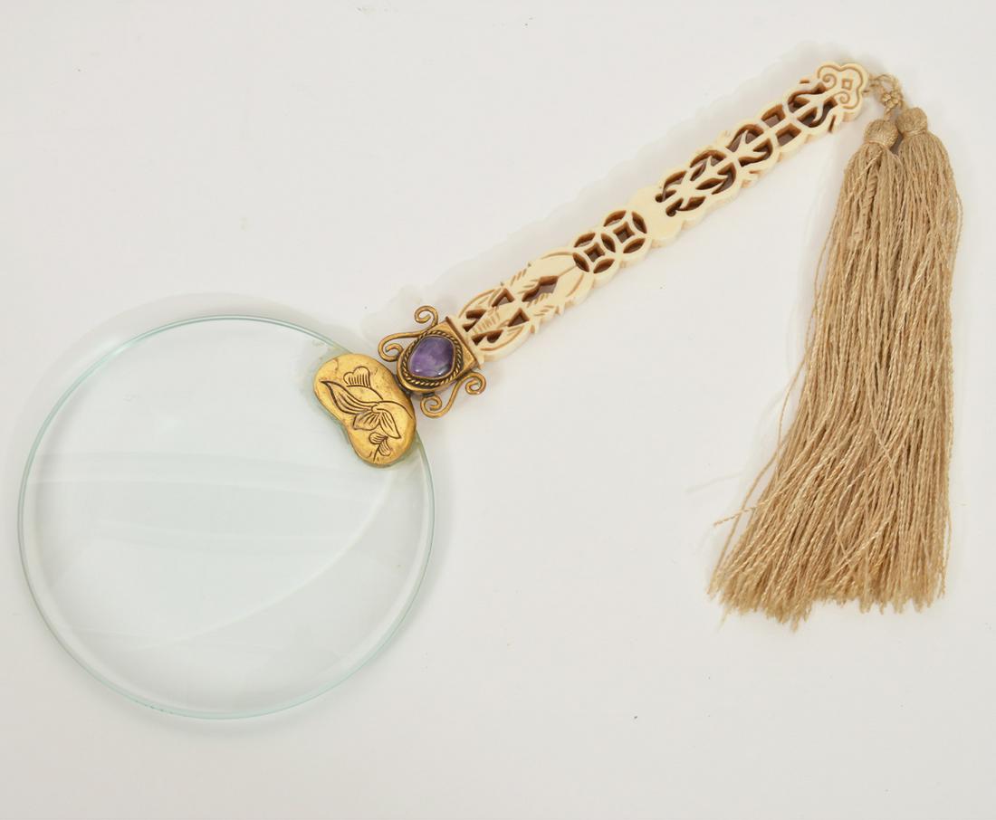 Chinese Maginifying Glass with Bone Handle: Chinese carved bone handle with tassel magnifying glass, 9" long, with tassel 13". Glass 3.75" across. Condition report: Good, no issues, please examine all photos closely. Contact C. Biddle Auction G