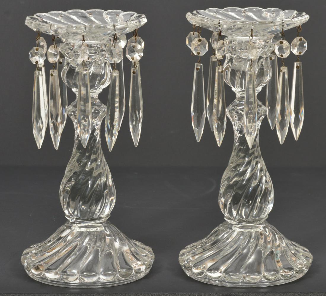 Manner of Baccarat Crystal Mantle Lusters: Twisted spiral candlestick mantle lusters with hanging faceted prisms. 5" W base x 9.5" H. Condition report: Good condition, missing 4 hanging crystals, some surface scratches on top of each luster, p