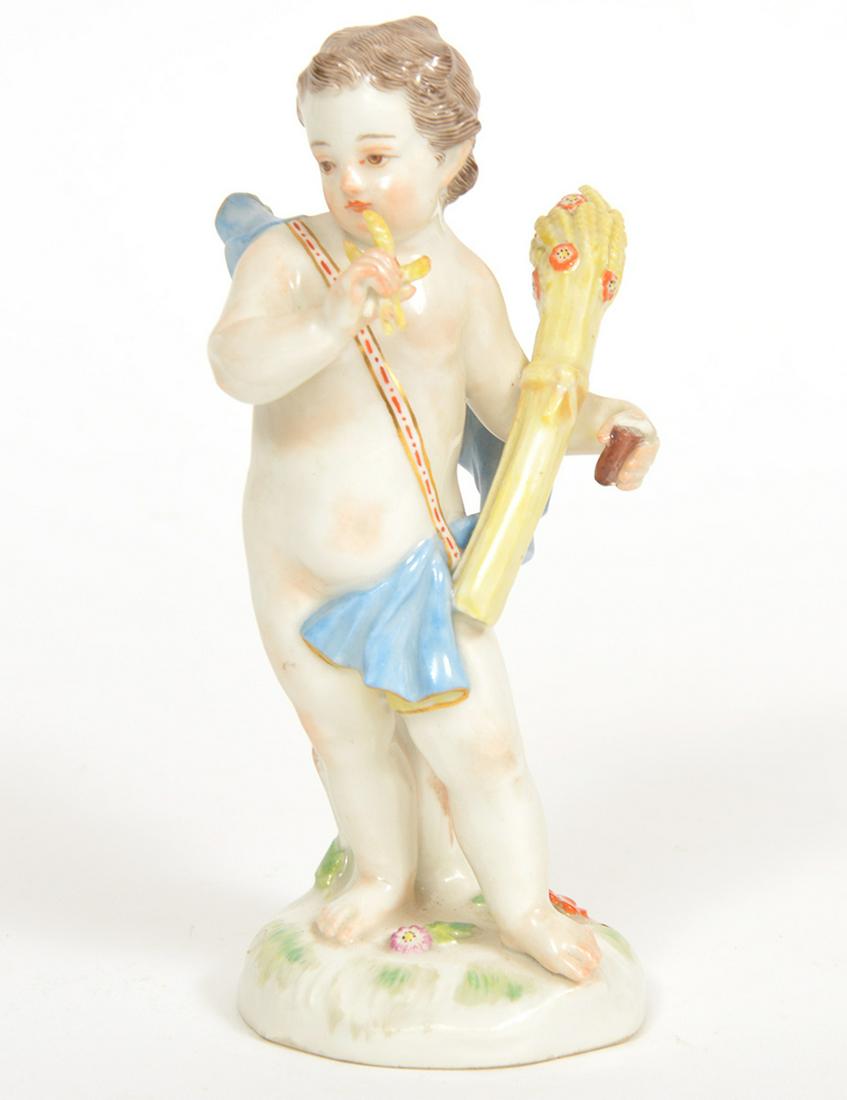 Meissen Porcelain Figure of Boy with Wheat Sheaf: Meissen porcelain figure of a boy carrying a wheat sheaf and draped with a blue cloth. Marked on bottom and numbered A67. Measures 5.5"H x 2.25"W x 2.5"D. Condition report: good condition, minor resto
