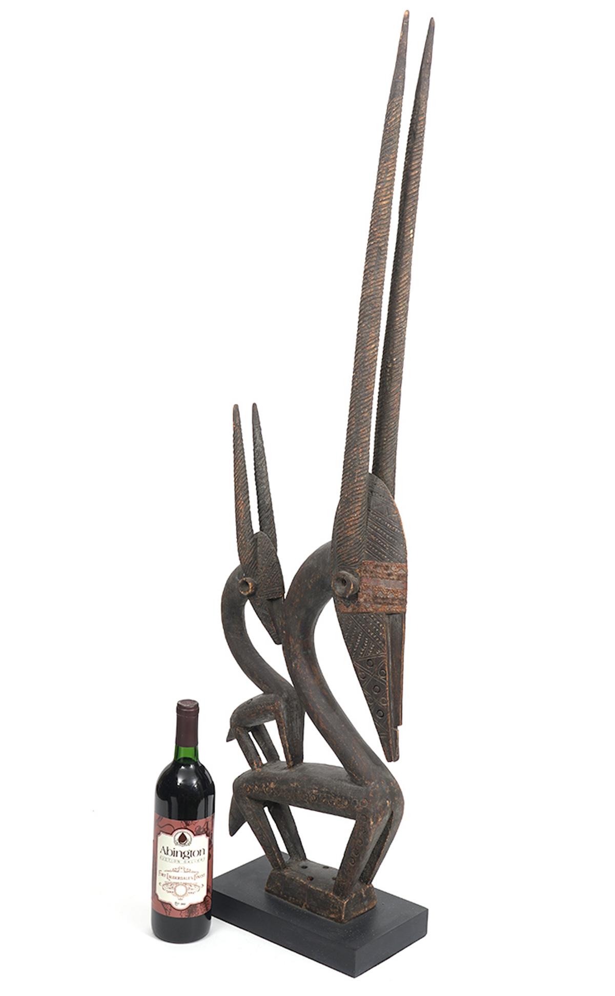 African Carved Wood Antelope Formed Figures: African hand-carved wood two antelope formed figures with tapered antlers. Measures 10.5" x 45". Condition report: Good condition, no issues, please examine all photos closely. Contact C. Biddle Aucti