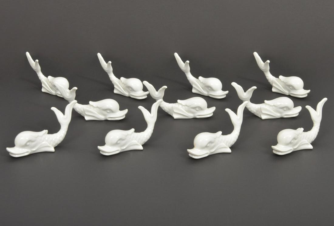 11 Richard Ginori Place Card Holders: 11 Richard Ginori Italian porcelain place card holders shaped like white dolphins and marked on bottoms. 2"H x 3 3/4"L. Condition report: Good condition, no issues, please examine all photos closely.