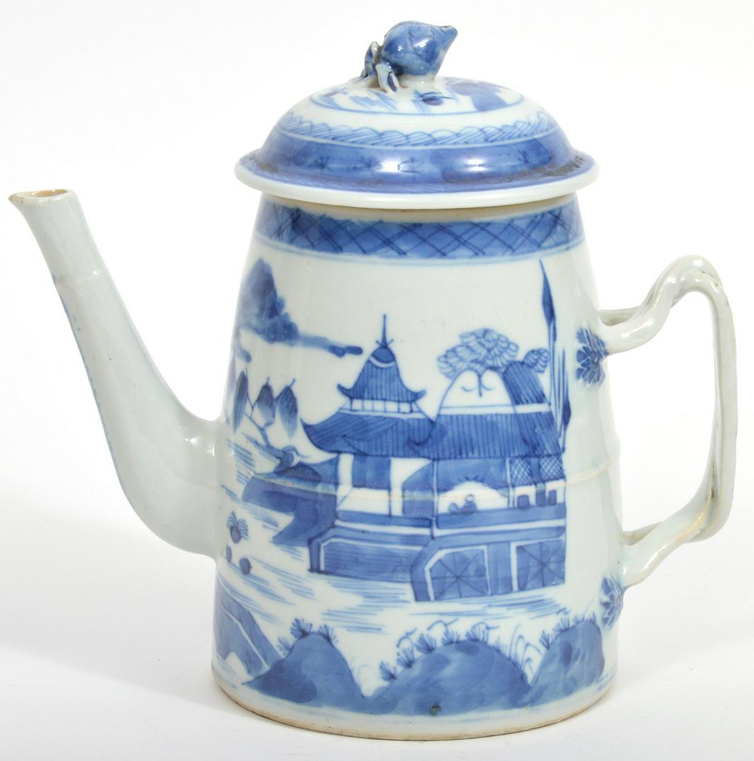 Chinese Blue and White Porcelain Teapot: Chinese blue and white porcelain teapot with village scenes, figural shell finial. Measures 7.5" x 8"W. Condition report: chip in finial, chip in underside, minor crack near base of spout, chips/break