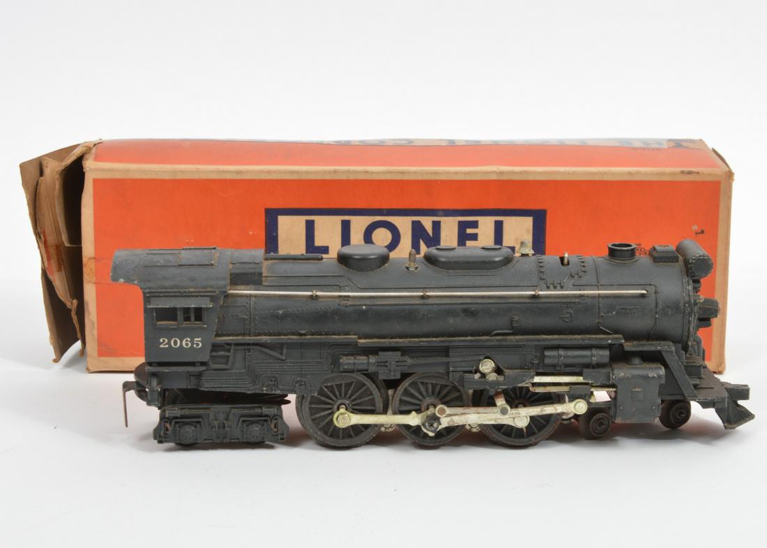 Lionel Trains Locomotive w/ Smoke Chamber No. 2065: Lionel Trains locomotive with smoke chamber, No 2065. Measures 11"L x 2.5"W x 3.5"H. Comes with original box, in poor condition. Condition report: locomotive has much rust some minor paint loss, pleas