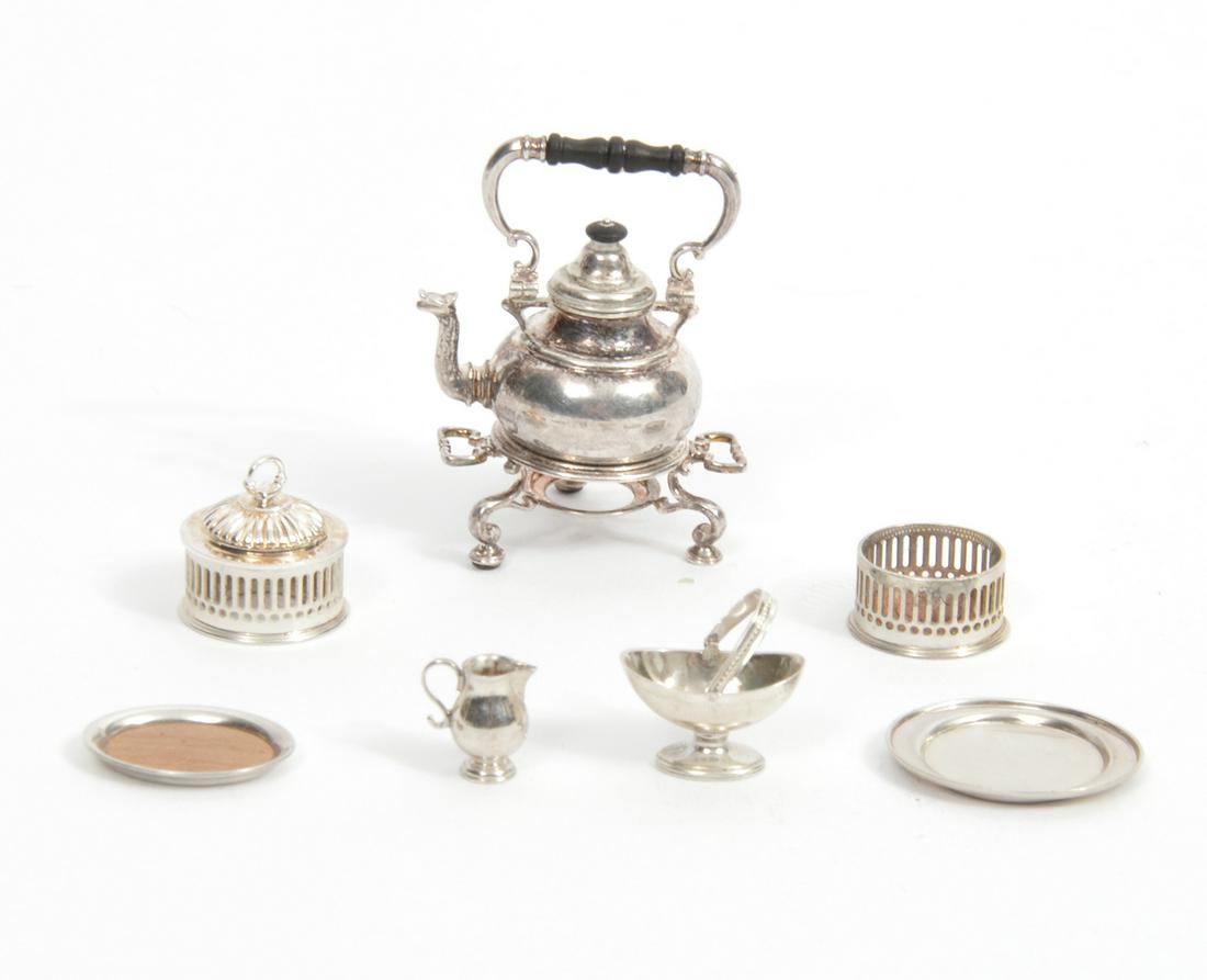 Sterling Miniature Mike Sparrow 7 Pcs. Grouping: Sterling miniature 7 piece grouping by Mike Sparrow includes tea pot with ebonized handle on tripod warmer, open work reticulated covered container, oval tray with rimmed edge, oval tray with wood cen