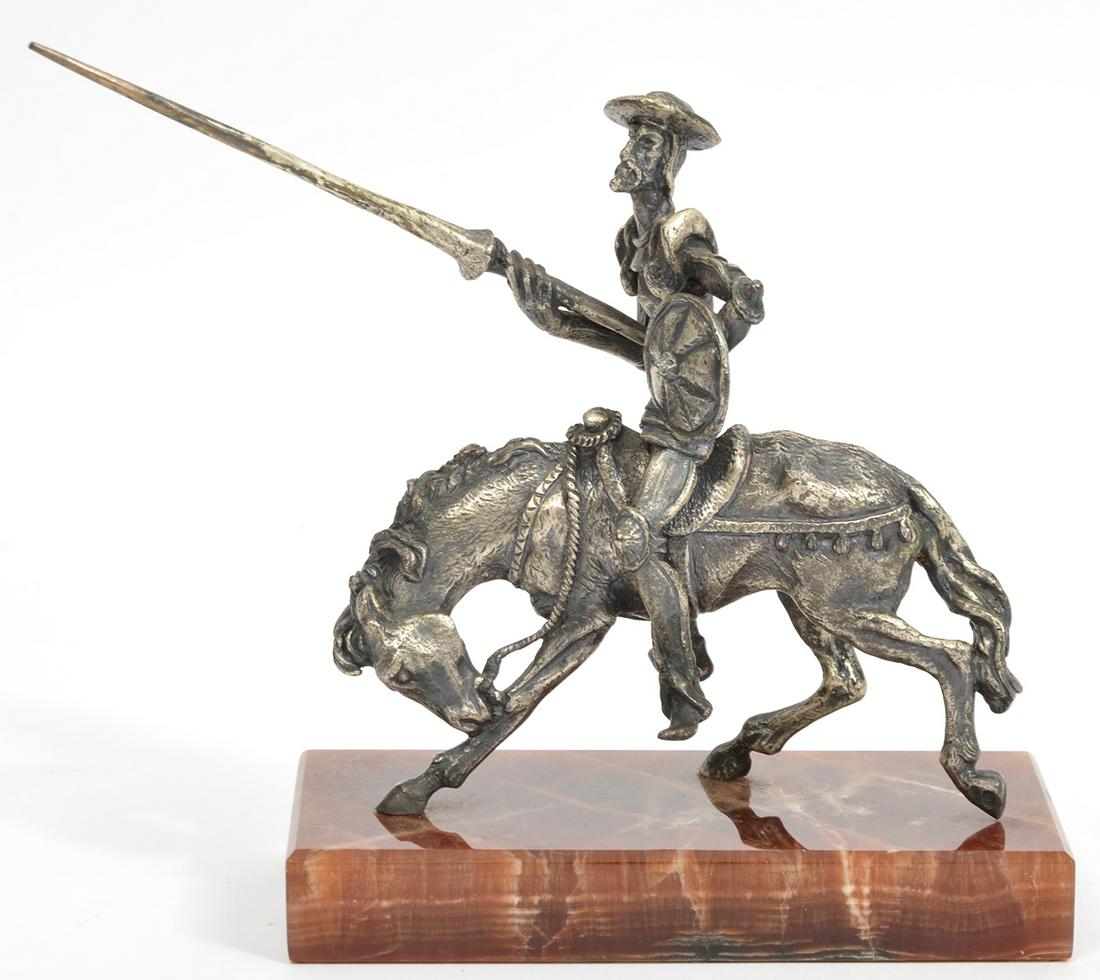 800 Silver Sculpture Don Quixote Horseback: 800 Silver sculpture of Don Quixote on horseback with spear, mounted on rectangular onyx base. Silver mark on horse's hoof. Measures 5.5"L x 2.75"W x 6.25"H. Weight - 1008gr. Condition report: Good co