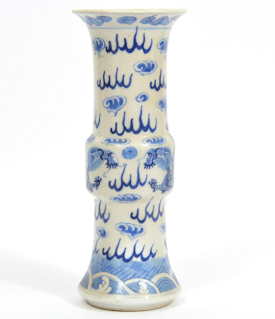 Chinese Blue & White Porcelain Gu Vase: Chinese blue and white porcelain Gu vase decorated with cloud formations and dragon figures. 4 Character mark on underside. Measures 4"W x 10"H. Condition report: Good condition, no issues, please exa
