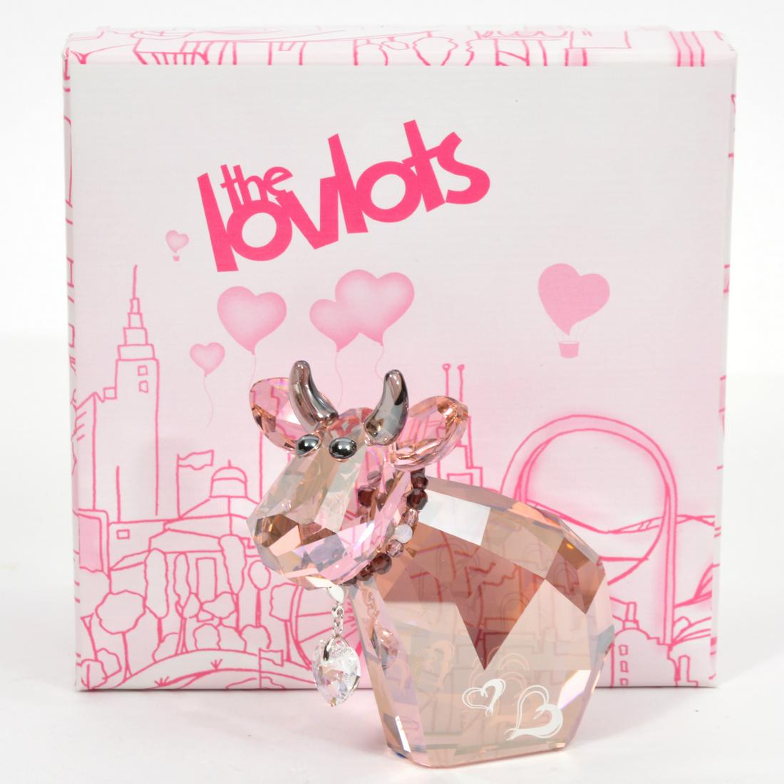 Swarovski Crystal 2011 Lovlots Charming Mo Figure: Swarovski Crystal 2011 Limited Edition Lovlots 'Charming Mo' figure, pink crystal with satin horns, removable heart charm necklace. Measures 3.5"L x 2"W x 3.5"H. Comes in original box and booklet. Goo