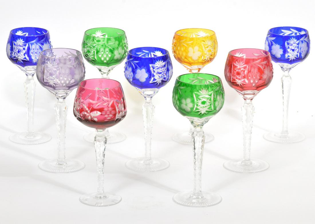 9 Pc Bohemian Cut To Clear Crystal Wine Goblets: 9 Piece Bohemian cut to clear crystal stemmed wine goblets, multi-color set with floral and fruit motif. 8 measure 3" x 8.25", one piece 1/4 inch shorter. Contact C. Biddle Auction Gallery for more de