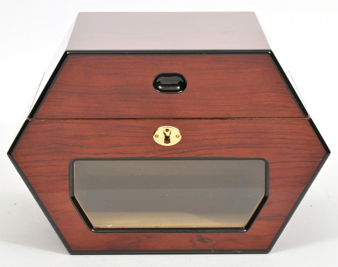 Cuban Crafters Rueda Humidor: Cuban crafters Rueda rosewood humidor with high gloss shine, Spanish cedar interior and can accomodate 60 cigars. There is a glass front window, brass hardware and a hygrometer. Measures 11 1/8"W x 9 
