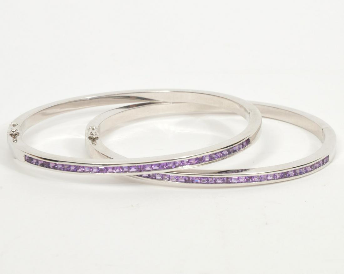 Pr. Sterling Bangles with Purple Gem Stones: Pair of sterling bangles with purple gem stones and double security closures and marked 925. Measures 7.5" inside circumference, total weight 46.7 grams. Condition report: good, please see photos. Pro