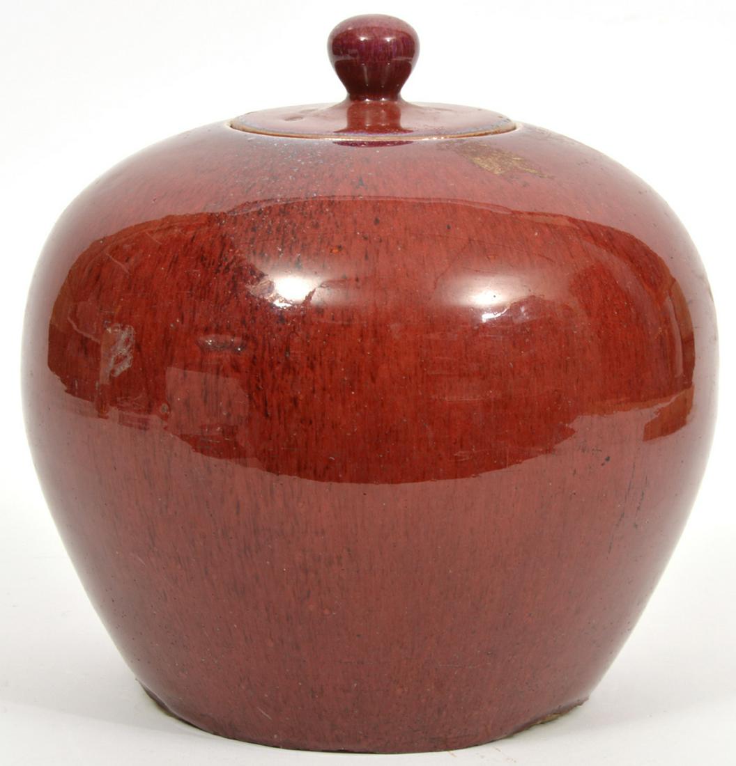 Chinese Oxblood Sang de Boeuf Covered Jar: Chinese oxblood sang de boeuf covered jar, measures 8.5"W x 8.25"H. Condition report: Chips to lid, inner rim and underside edges, common light surface wear throughout. Please examine all photos close