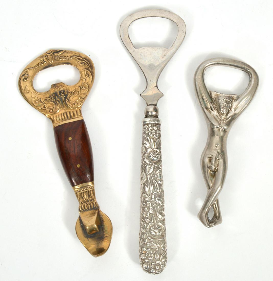 3 Whimsical Decorative Bottle/Can Openers: 3 whimsical decorative can and bottle openers including one Kirk & Sons Repousse opener (5 5/8"L); one gold tone & wood bottle opener marked Thailand (4.5"L); one nude silver tone opener (3.75"L). Con