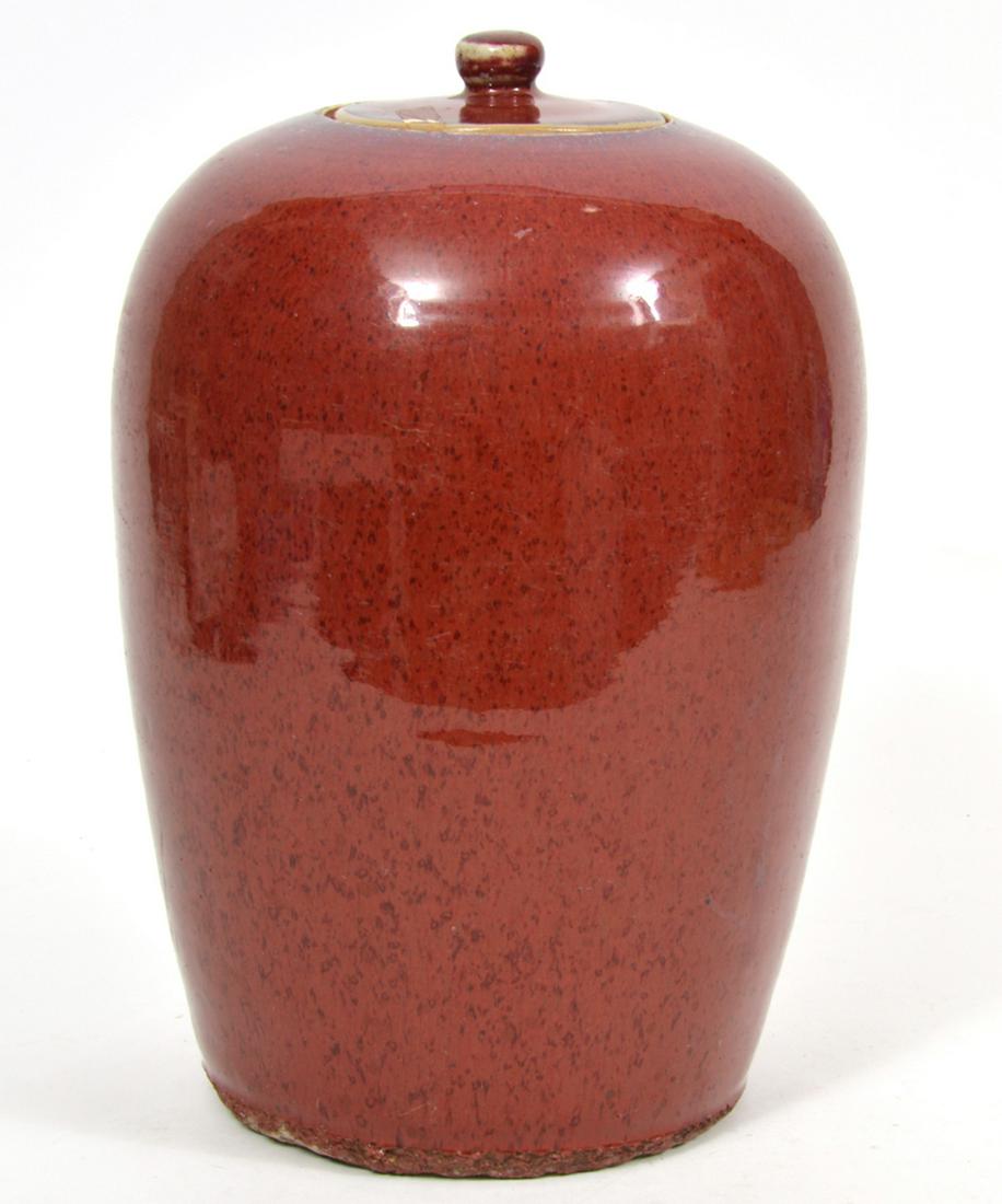 Chinese Oxblood Sang de Boeuf Covered Jar: Chinese Oxblood Sang de Boeuf covered jar, Underside has wax stamp signature. Measures 8"W x 12"H. Condition report: Two chips to lid, bottom edges have chips, other common wear scratches, scuffs, for