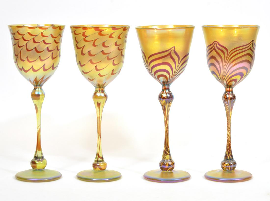 Two Pairs Rick Strini Iridescent Wine Goblets: Two pairs of Rick Strini signed hand-blown iridescent yellow art glass wine goblets; two ribbon pattern decoration, two pulled feather-style pattern. Signed and dated '2000' underside. Measures 10.5"H