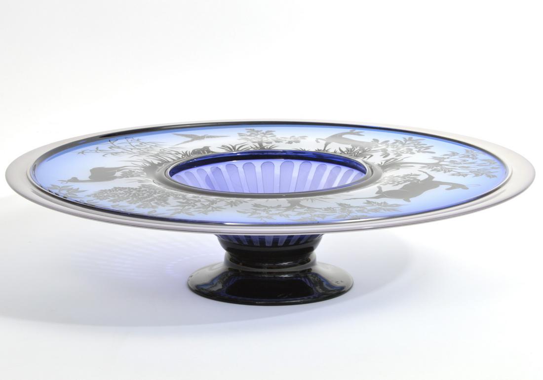 Gary Ginetti Cameo Glass Centerpiece Bowl: Gary Ginetti etched cameo glass pedestal centerpiece bowl, featuring black woodland scenes of deer and birds, with gradient hues of blue background. Signed underside by artist and dated 2002. Measures