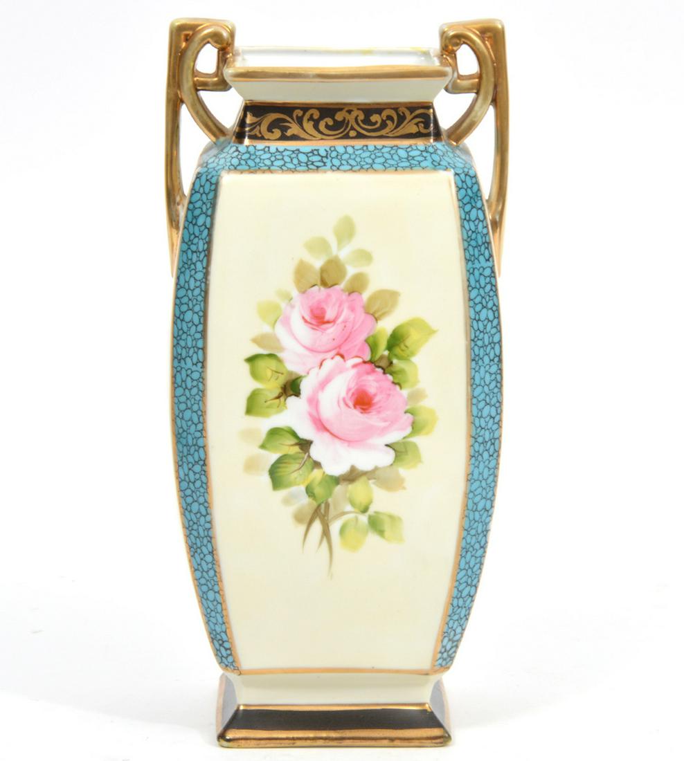 Hand-Painted Rose Motif Nippon Vase: Hand-painted Nippon vase, squared body featuring rose motif on each panel, light blue pebble pattern borders and gilt double handles. Stamped underside. Measures 4.5"L x 4"W x 9.5"H. Condition report: