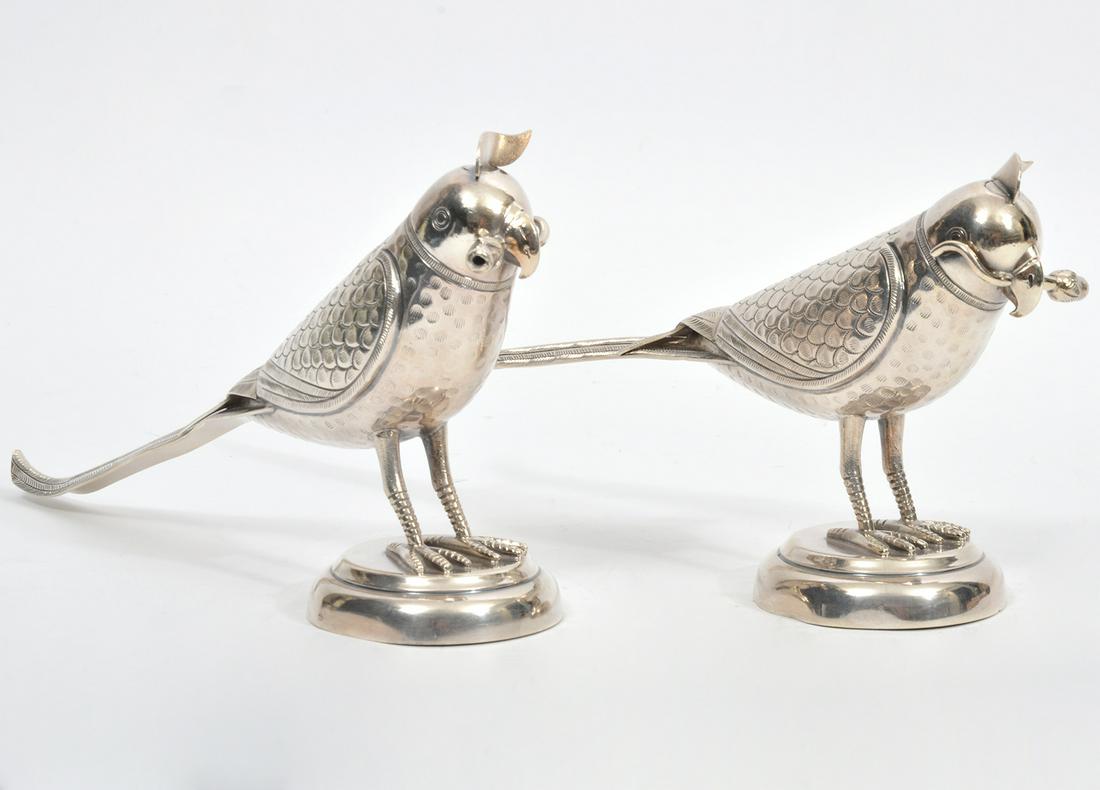 Pair of Sterling Silver Standing Parrot Flasks: Pair of sterling silver standing parrots holding flowers in beak, on circular pedestals. Chased plumage, screw top feather finial on head. Each measures 5"H x 8.5"L . Total weight - 472g. Stamped 925