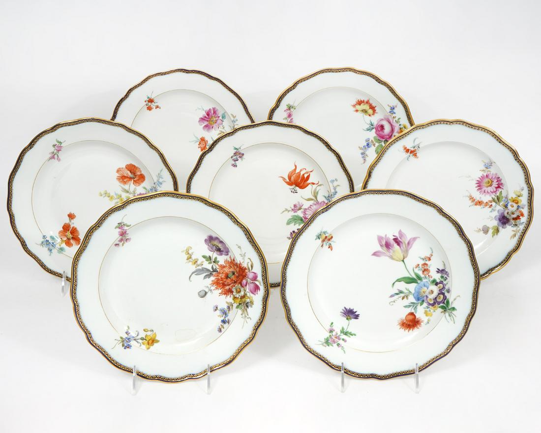 Set of 7 Meissen Porcelain Floral Plates: Seven Meissen porcelain floral and gilt dinner plates, marked on the underside. 9.75" W. Condition report: no major damage, some wear to paint and bottom of plates. Please examine all photos closely. 