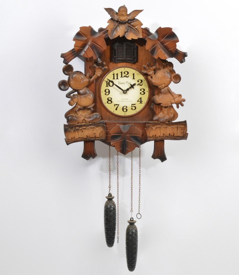 Disney Mickey & Minnie Musical Cuckoo Clock: Disney Time Mickey & Minnie musical wood quartz cuckoo clock, Japanese made, features acorn weights, bird pops out of doors at top. Measures 13"L x 8"W x 15.5"H. Condition report: Good condition, no i