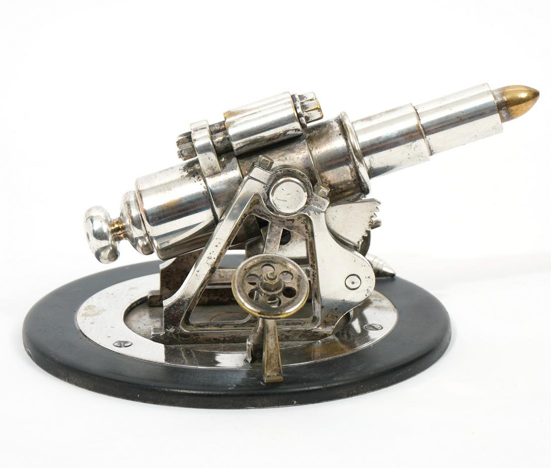 Rare Rotating Artillery Canon Lighter Striker: Silver-plated rotating canon with ship style wheel, moves up and down and 360 degrees. The brass end of the gun is removable to reveal striker and flint, bullet shaped match strike at base. No marking