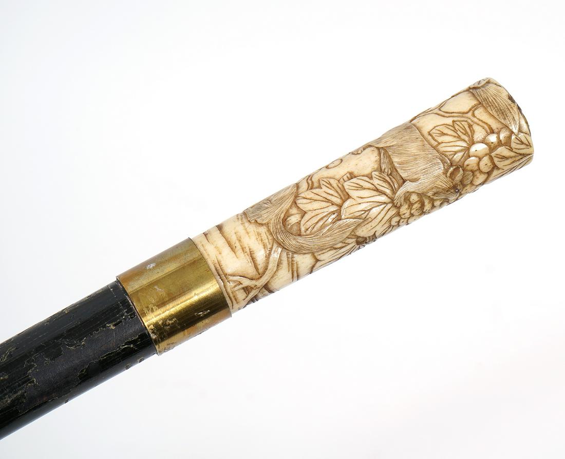 Ebonized Wood Cane With Hand-Carved Handle: Ebonized wood cane with hand-carved handle featuring mice among berries and leaves. Measures 36.5"H. Condition report: Common wear, scratches to wood, Please examine all photos closely. Contact C. Bid