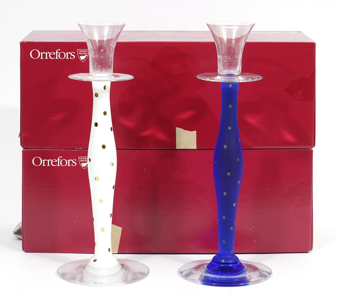 Two Orrefors Anne Nilsson 'Celeste' Candlesticks: Two Orrefors 'Celeste' candlesticks designed by Anne Nilsson, white with gold polka dots, blue with grey dots, frosted glass. Both measure 11.5"H x 4.25"W and come in original boxes. Condition report: