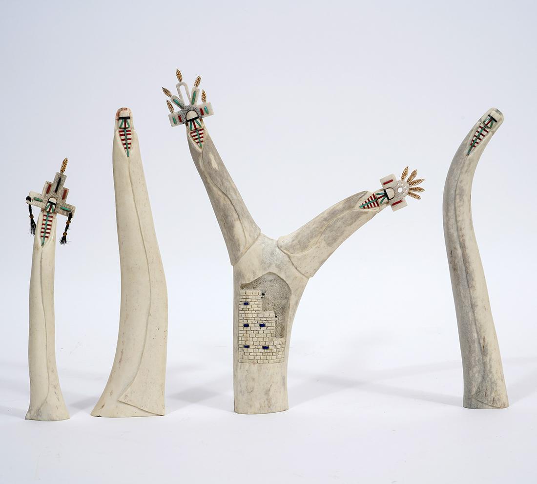 Four Signed Carved Bone Native American Figures: Four contemporary artisanal Native American carved ornamental figures with inlaid stone, artist signed underside "GJB" and numbered. Double figure measures 12.25"H x 9"W, Three singular figures measur