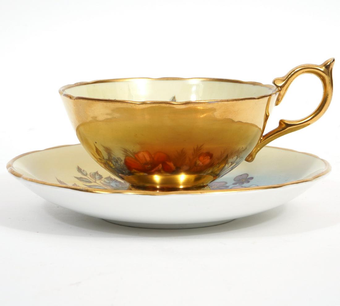 Aynsley Cabbage Rose JA Bailey Tea Cup & Saucer: Aynsley English bone china tea cup and saucer, featuring cabbage rose among other flowers, gilt exterior on cup and rim of saucer. Signed bottom right corner. Cup measures 2.5"H x 5"W, saucer 5.75"W.