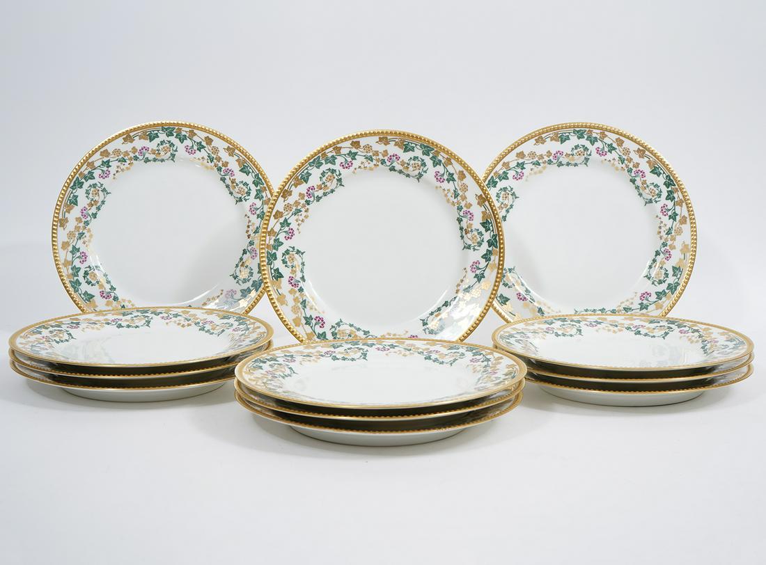 Set of 12 Jean Pouyat French Limoges Dinner Plates: Set of 12 Jean Pouyat French Limoges dinner plates, 9.5". Borders decorated with red, green and gold leafy grape vines, raised dotted gilt rim. Underside hallmarked. Condition report: Minor gilt loss 