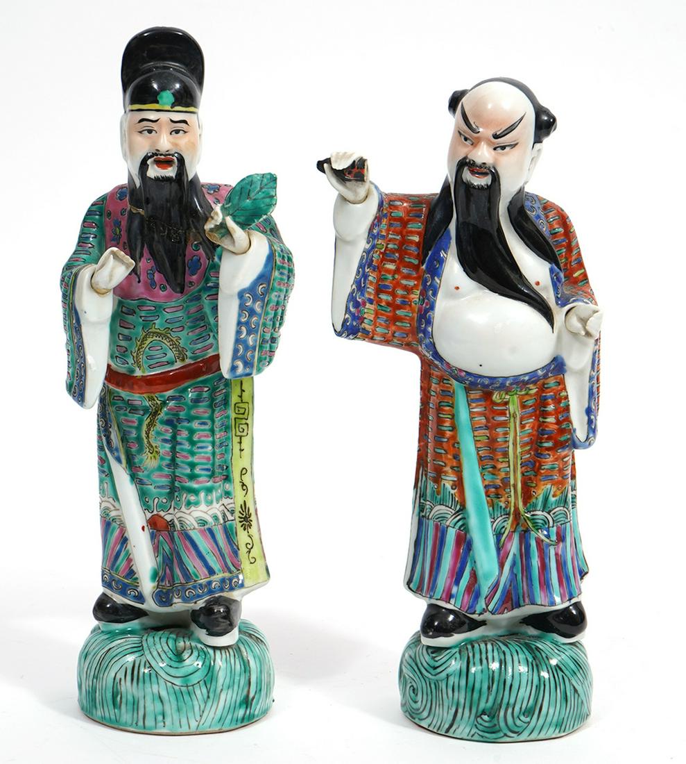 Two Chinese Porcelain Court Figures: Two Chinese porcelain court figures, bearded elders standing on grassy mound, measures 9.25"H x 4.5'W x 2.5"D. Condition report: Figures have broken fingers and missing pieces from objects held, right