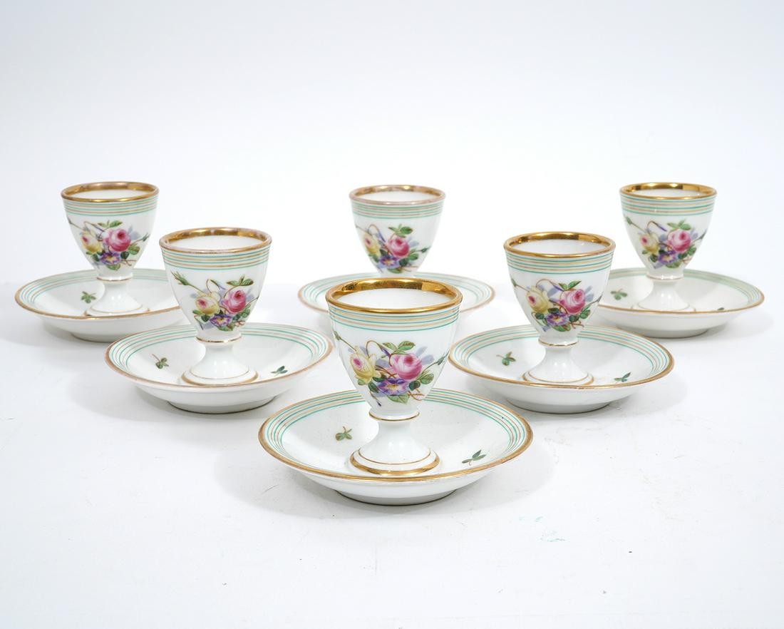 6 CT Tielsch German Porcelain Egg Cups: 6 hand painted German porcelain egg cups, monogrammed & marked on underside. Decorated with flowers and leaves and accented in gilt. Measures 3"H x 3.75"W. Condition report: minor wear to gilt, please