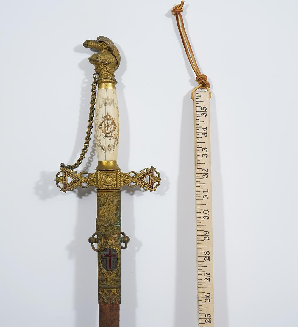 Masonic Knights Templar Sword & Scabbard: Ceremonial Masonic Knights Templar sword, etched bone grip with knight helmet on top. Measures 5"W x 39"L. Condition report: wear, oxidation, rust throughout, please examine all photos closely. Contac