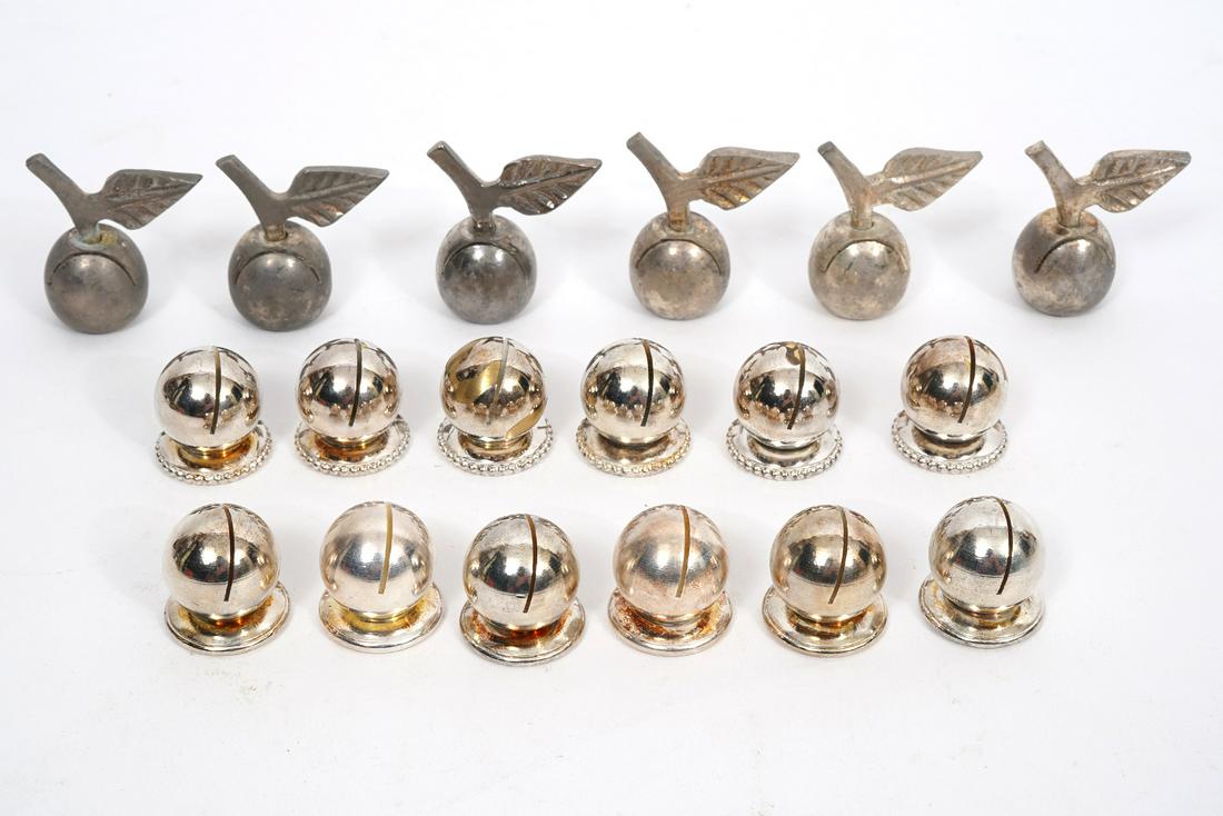 Group of Silver-plated Place Card Holders: Grouping of 18 silver plated place card holders. 12 are in a Bergdorf Goodman box and 6 are cherry place card holders. All are unmarked. Cherries are 1.5" H and balls at .75" H. Condition report: some