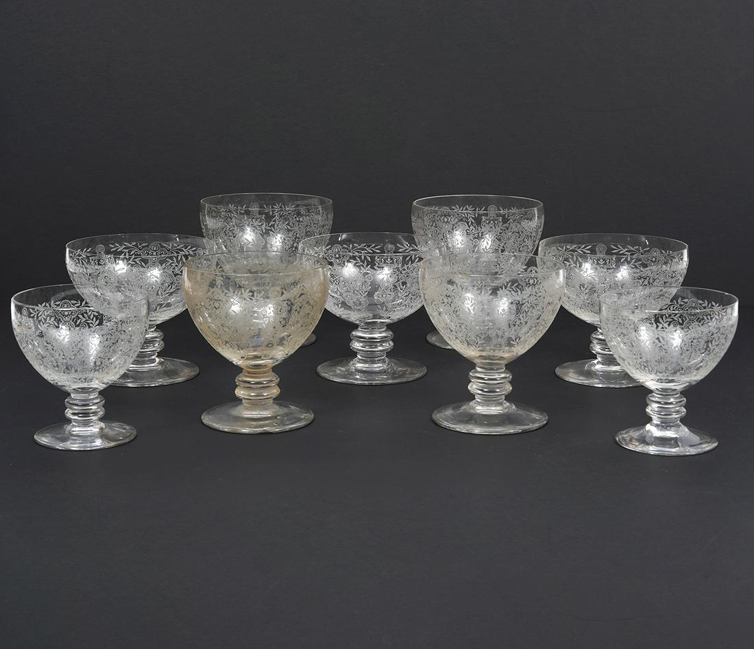 9 Baccarat Etched Crystal Stemmed Glasses: 9 Baccarat etched crystal stemmed glasses decorated with Art Deco designs and branches with leaves. Two measure 3 7/8"H x 3 5/8"W; three 3.25"H x 3.75"W; two 3.5"H x 3.25"W; two 3"H x 2.75"W. Conditio