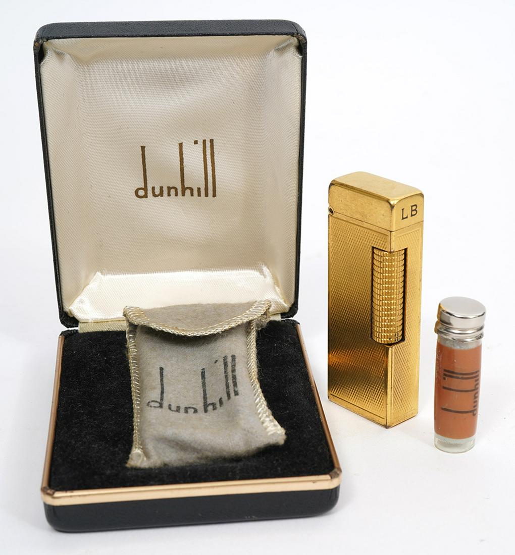 Dunhill Gold-Tone Lighter Original Box: Dunhill gold-tone lighter with cloth sleeve, original box and booklet. Measures 2.5"H x 0.75"W. Condition report: Good condition, no issues, please examine all photos closely. Contact C. Biddle Auctio