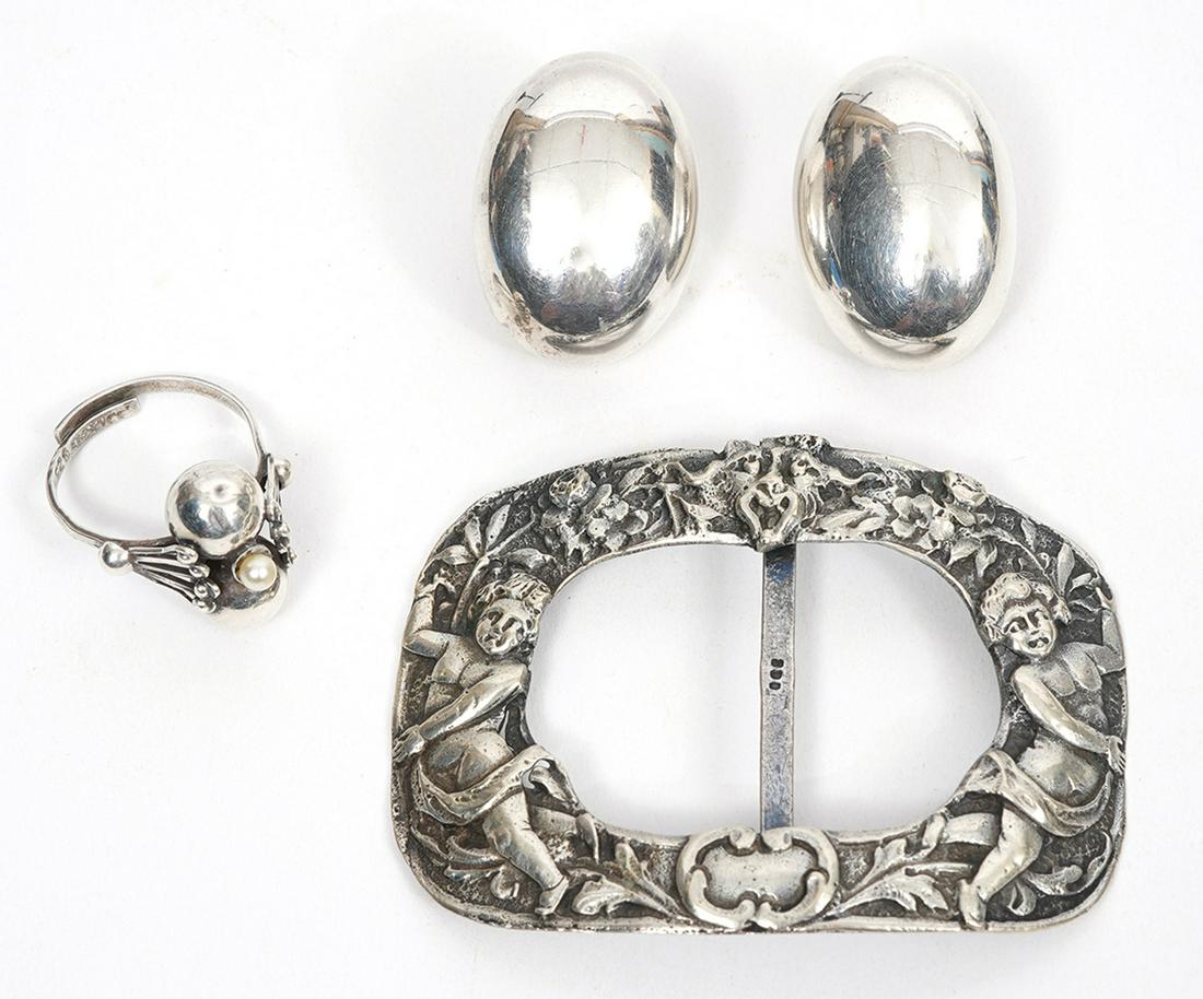 Mixed Lot of Silver, Earrings, Buckle and Ring: Lot includes: 800 silver repousse cherubs belt buckle, measures 2.25"L x 1.25"W. Weight -11.0g; Mexican sterling silver, bean-shaped clip earrings. Stamped on inside. Measures 1"L X 0.75"W. Weight - 1