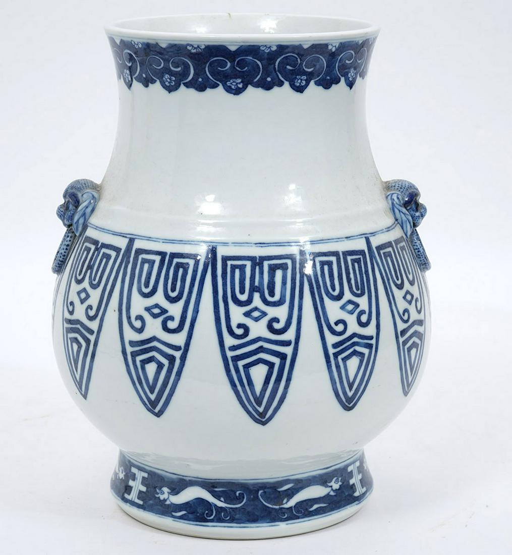 Chinese Porcelain Blue and White Vase: Chinese blue and white porcelain vase. Foo dog on side. Marked on bottom. 11.5" H x 9" W. Condition report: good condition with minor signs of wear, see photos. Please examine all photos closely. Cont