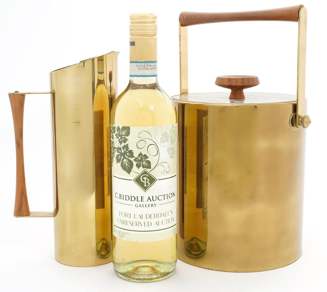 Italian MCM Brass-Tone Ice Bucket & Pitcher: Italian Mid-Century Modern ice bucket and pitcher, each with wood handles. Pitcher measures 9.5"H x 5.5"W, ice bucket 9"H x 7.75W. Underside stamped "Made in Italy". Condition report: Common wear scra