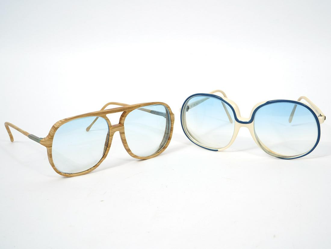 Two Italian Oversize Designer Glasses: Viva Boots, natural light wood frame aviator-style frames. Measurements: Frame width 140 mm; Frame height 55 mm; Temple length 125 mm; Riviera, creme-color with linear blue accents, light blue tint le