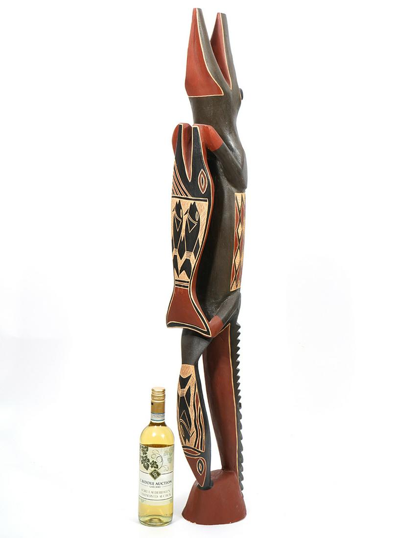 Bakulanay Marawilli Crocodile Wood Carving: A special ceremonial wood carving of the a crocodile ancestor and parrot fish with the sacred clan design for the Madarrpa people. Bakulanay Marawilli is a member of the Madarrpa people. The region is