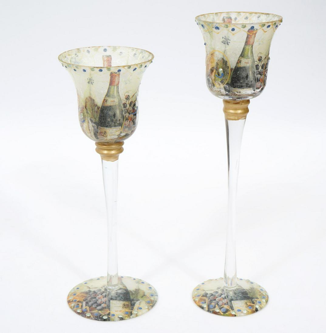 2 Decoupage Tea Light Candle Holders: 2 tea light candle holders in the form of wine glasses with colorful decoupage rice paper on inside of bowls and bottom of rims. Decorated on outside with gilt designs and paint dots. Measures 9"H x 3