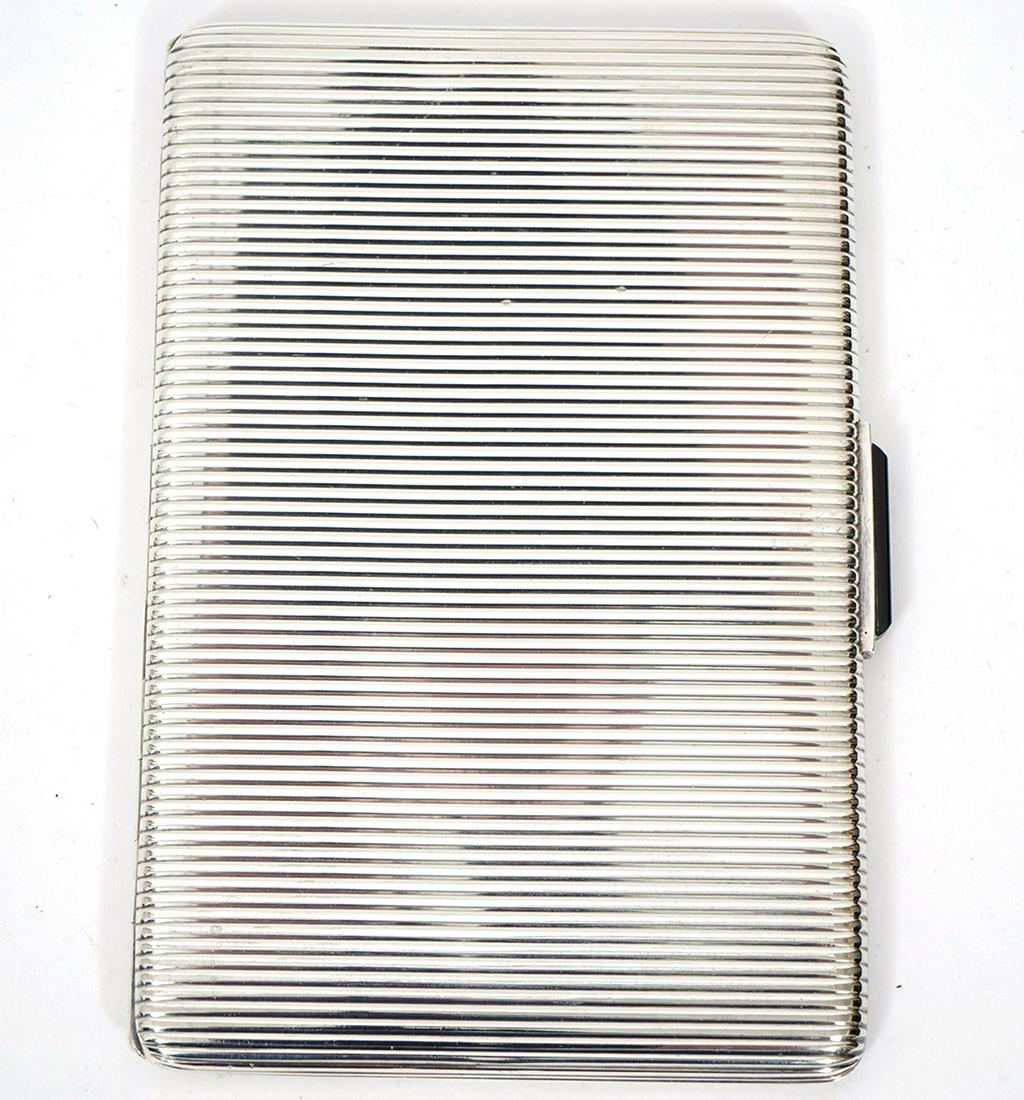 Sterling Ribbed Cigarette Case with Onyx Clasp: 1940's ribbed sterling cigarette case with onyx clasp, marked 925 on inside. Etched 1940 inside cover. Total weight 166 grams. Measures 5"L x 3.25"W x .25"D. Condition report: light surface wear, plea