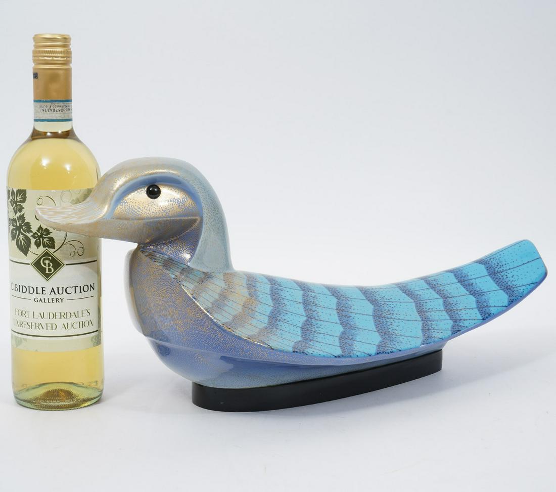 Oggetti Mangani Italian Porcelain Duck Sculpture: Giulia Mangani for Oggetti Italian porcelain duck sculpture, signed with sticker underside. Painted with hues of blue and purple with gilt accents. Measures 18.5"L x 8.5"W x 8"H. Condition report: Goo