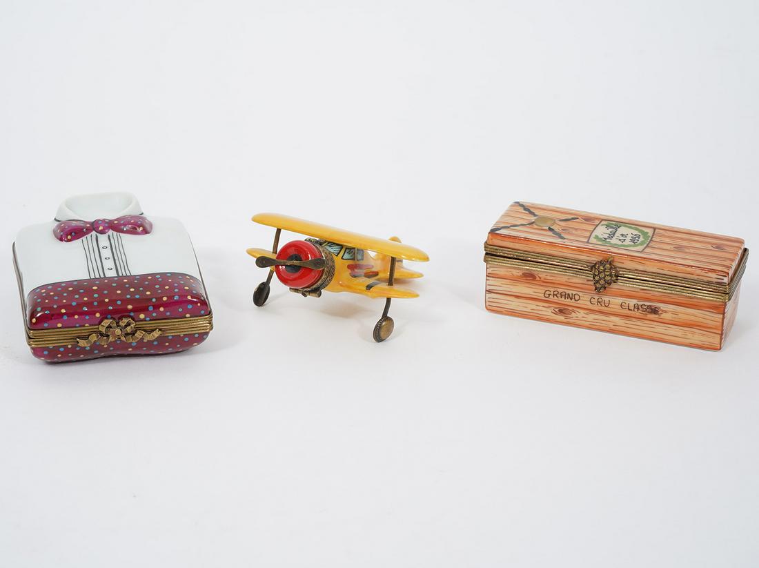Three Figural French Limoges Trinket Boxes: Propeller airplane, (2.25 x 2.25"W x 1"H); Grand Cru wine bottle in box (2.75"L x 1"W x 1"H); Dress shirt (2.5"L x 2"W x 0.75"H). Condition report: Good condition, no issues, please examine all photos
