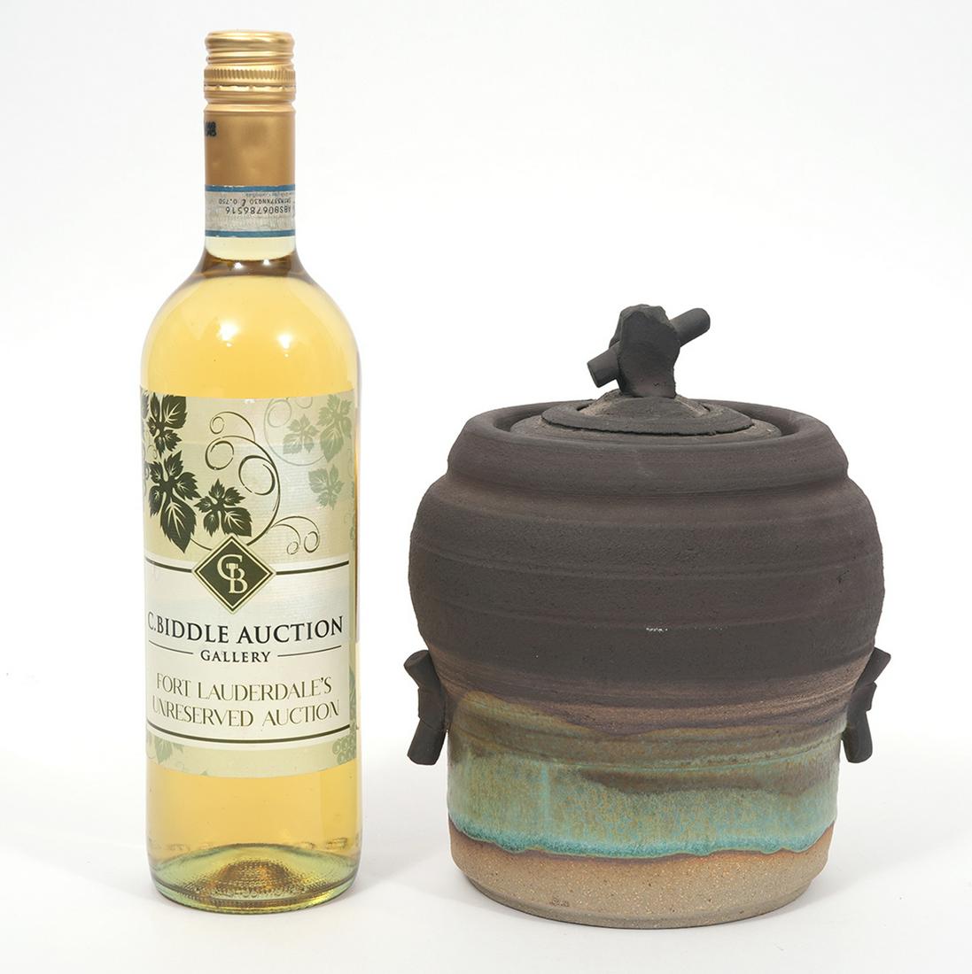 Ellen Schon Lidded Stoneware Jug: Ellen Schon, American Contemporary Ceramic Artist. Lidded stoneware jug with handles and finial, unglazed, splash of blue color in the band around the body of the jug. Signature etched on bottom. Meas