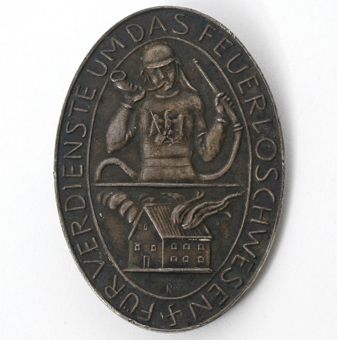 Prussian 900 Silver Fire Brigade Service Medal: Prussian, Circa 1934-36, 900 silver medal. Awarded to firefighters and civilians who developed and contributed to the brigade for 25 years or more. Measures 1.75"H x 1.25"W. Weight - 16.2g. Condition 