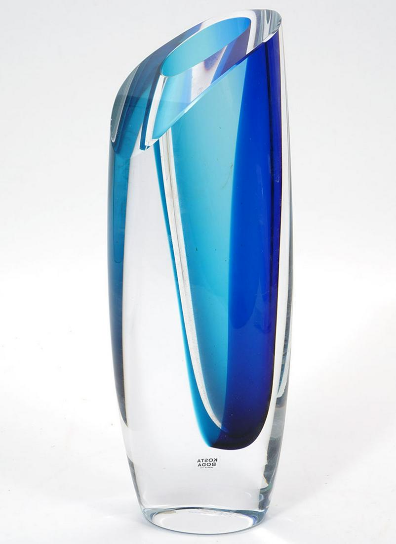 Kosta Boda Goran Warff Signed Art Glass Vase: Kosta Boda Swedish art glass vase, signed underside by artist Goran Warff. Blue Inside blue clear glass. Measures 11.5"H x 4"W. Condition report: Good condition, no issues, please examine all photos c