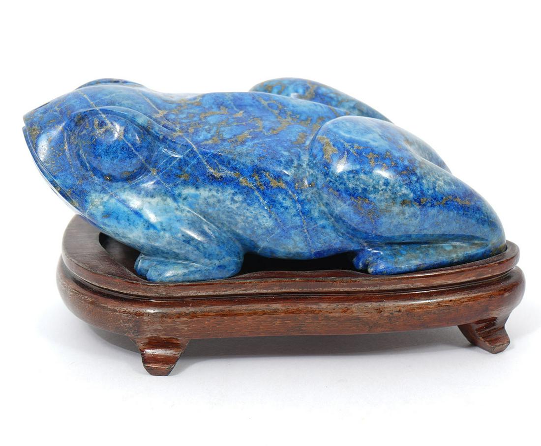 Lapis Lazuli Carved Frog on Wood Base: Lapis Lazuli carved frog on wood base, raised on 4 small feet. Frog measures 5.25"L x 3.5"W x 2"H; custom formed base 5.25"L x 3.5"W x 1"H. Condition report: good condition, please see all photos. C. 